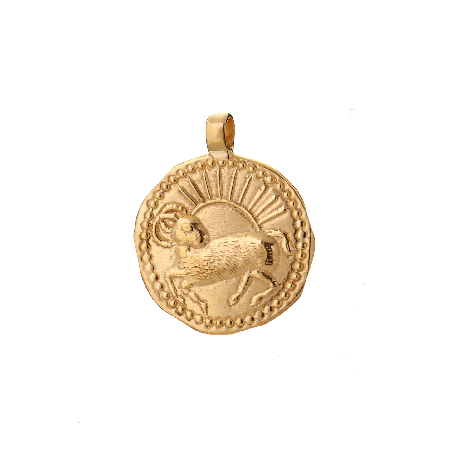 A golden talisman depicting a goat with a rising sun behind it representing Aries of the Zodiac.