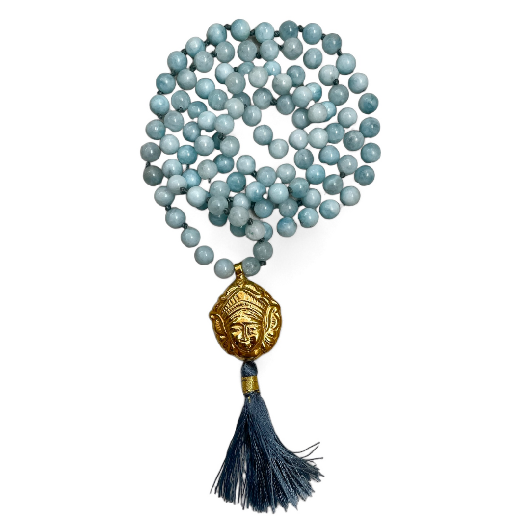 Aquamarine beaded mala with a gold-plated Tara charm, featuring a turquoise and gold color scheme.