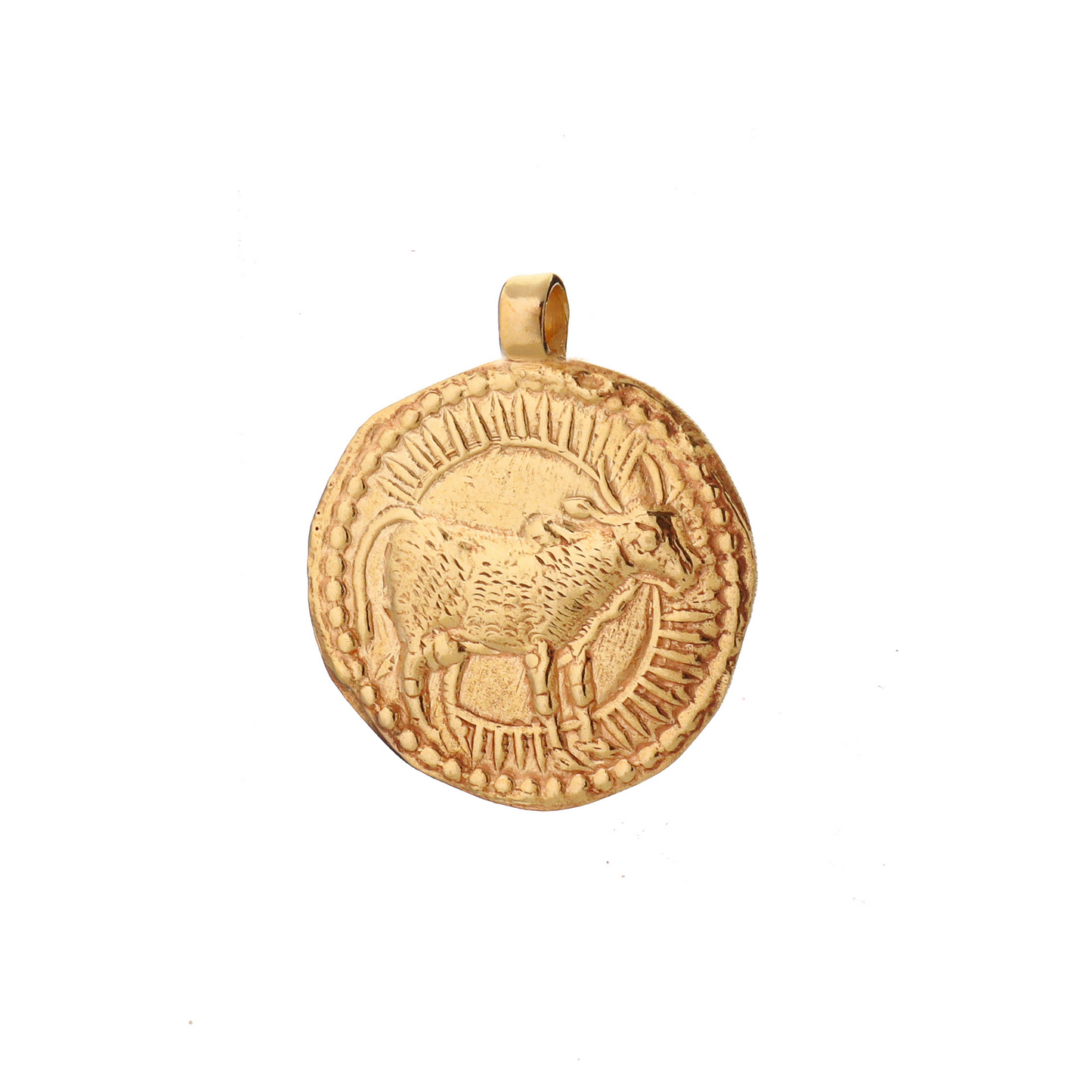 A golden talisman depicting a bull with a full sun behing it symbolizing Taurus from the Zodiac